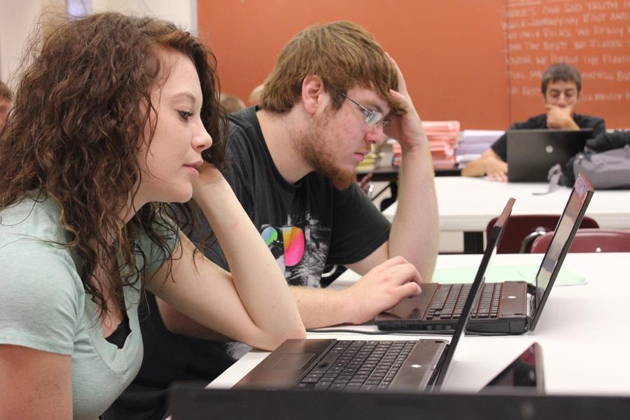 Seniors Tia Grover, Austin Belden, and Dakota Zimmerman use their school computers to work on an English assignment.