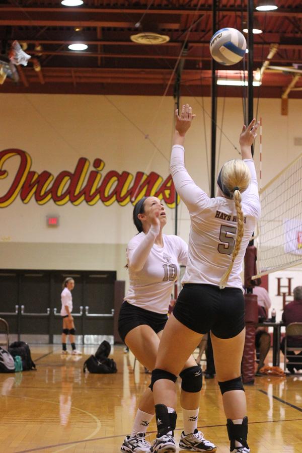 Junior Madison Prough sets the ball for senior Ashlyn Parrish at the Hays Tri on Sept. 5. On Sept. 9, the team traveled to Goodland and posted three victories.