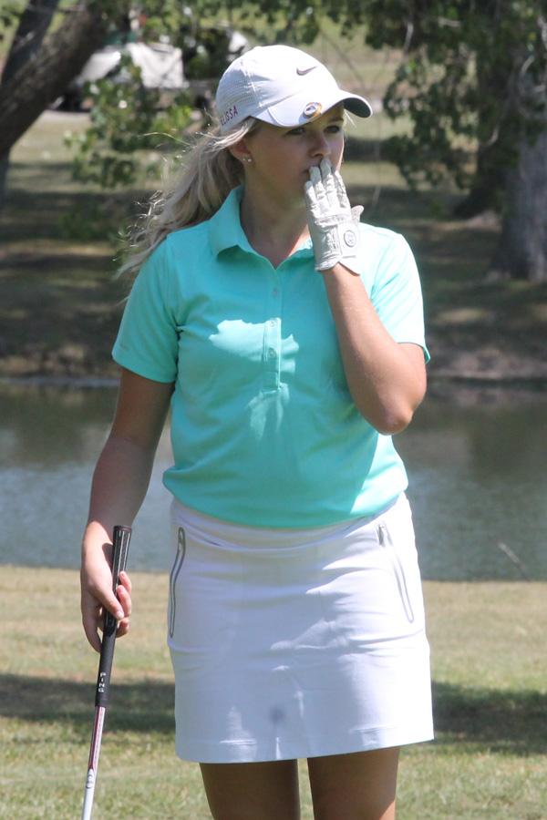 Senior Elissa Jensen reacts to a putt on the 4th hole at the Smokey Hill Country Club. Jensen placed second at the tournament.