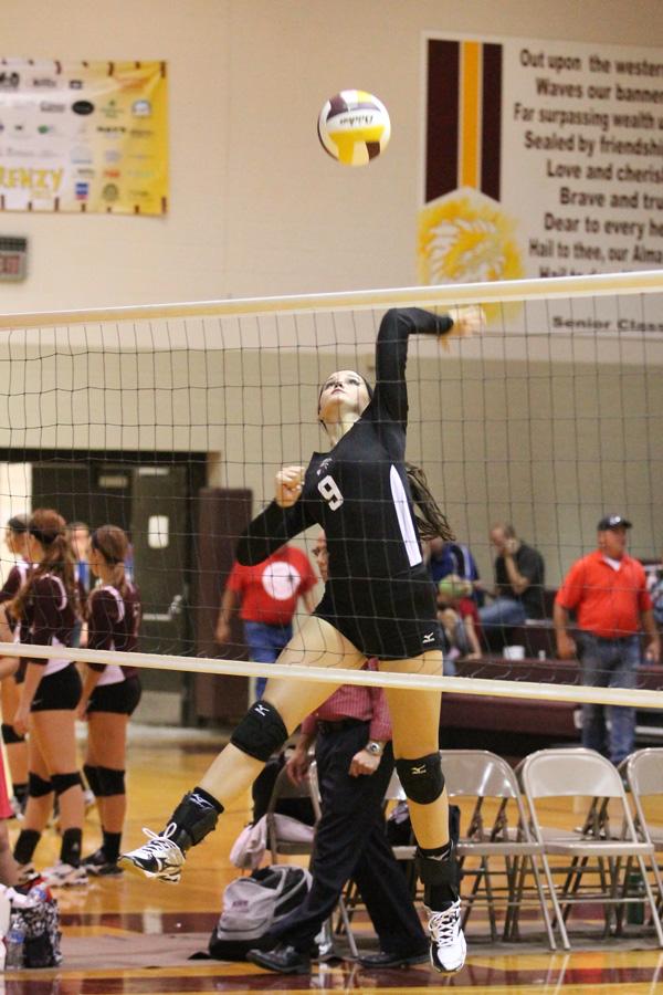 Junior Kylie Brown goes for a spike during the warm up at the Hays meet. The team went 1-2 at the Garden City Quad.