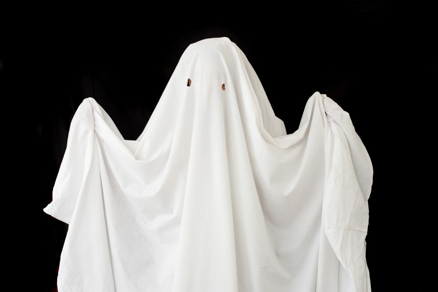 a figure wearing a halloween ghost costume