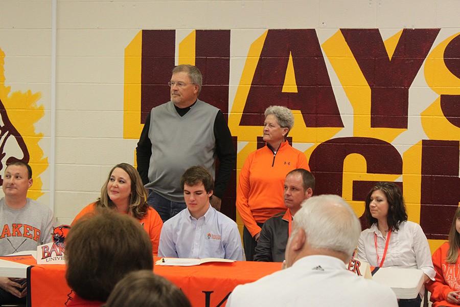 Ruder gets ready to sign to play golf for Baker. 