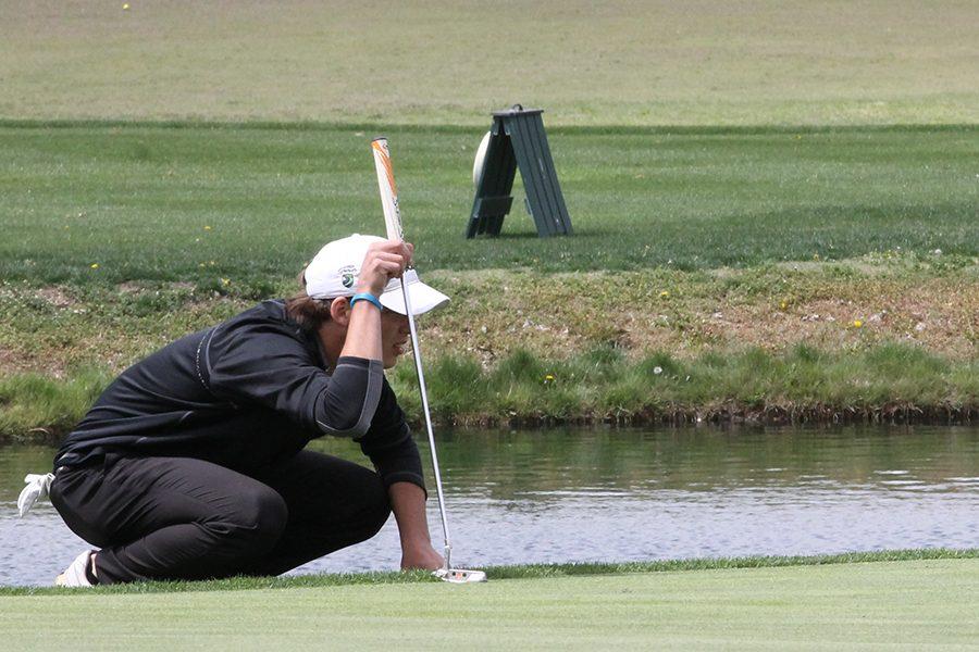 Senior Payton Ruder lines up his putt at the Bob Blazer Invitational on April 18. Ruder took sixth place individually with a score of 81.