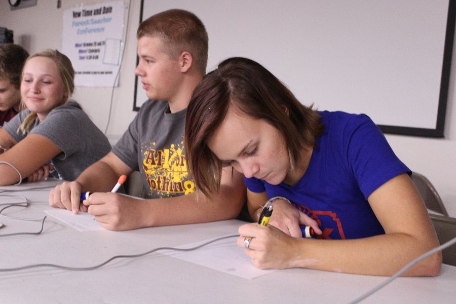 Senior Hannah Norris and junior Brennon Chapman solve a math problem during the Battle of the Brains.
