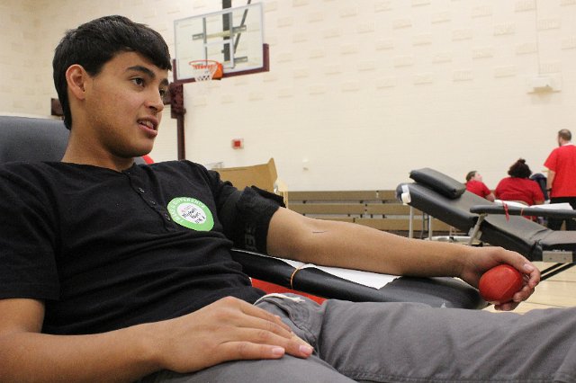 Senior Micheal Reyes donates blood.
One person giving blood can save up to three lives. pounds and be in good general health.