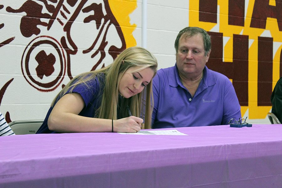 Senior Rachel Taylor signed to Dodge City Community College for volleyball on Nov. 30 in the cafeteria. 