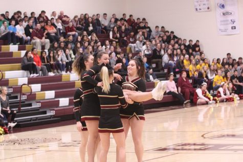 Varsity cheerleaders perform new routine at pep assembly