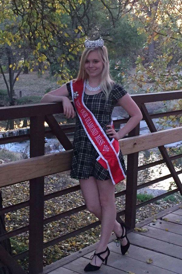 Sophomore Alycia McVay stands showing her Diamond Miss sash off.