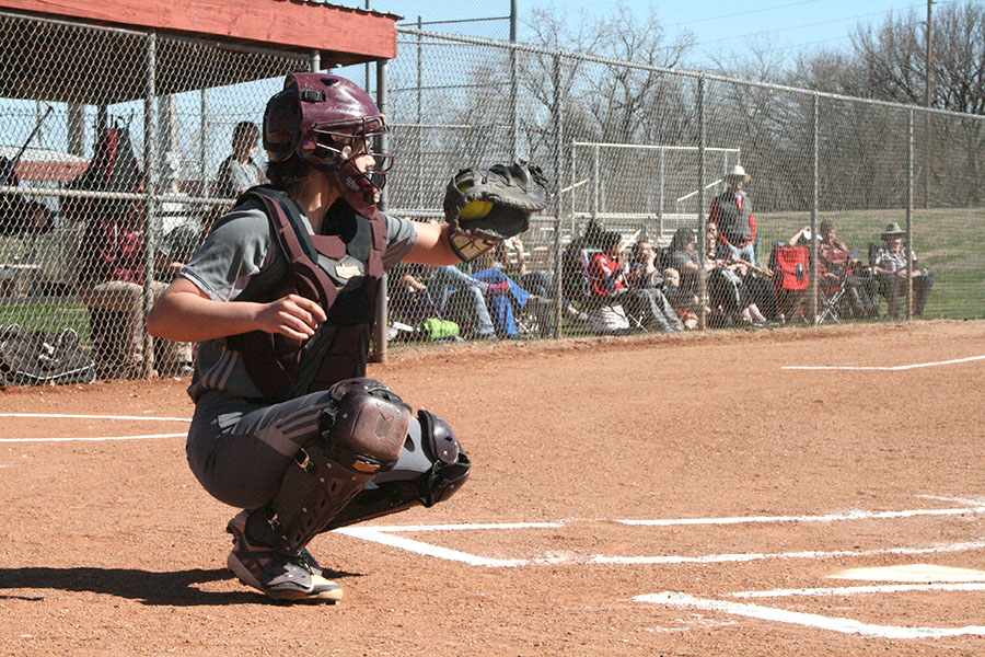 Sophomore catcher MacKenzie Fagan catches a ball from the picther and hopes for a strike in a recent game against the Dodge City Red Demons. On April 20, the Indians fell to the Great Bend Panthers at home. 