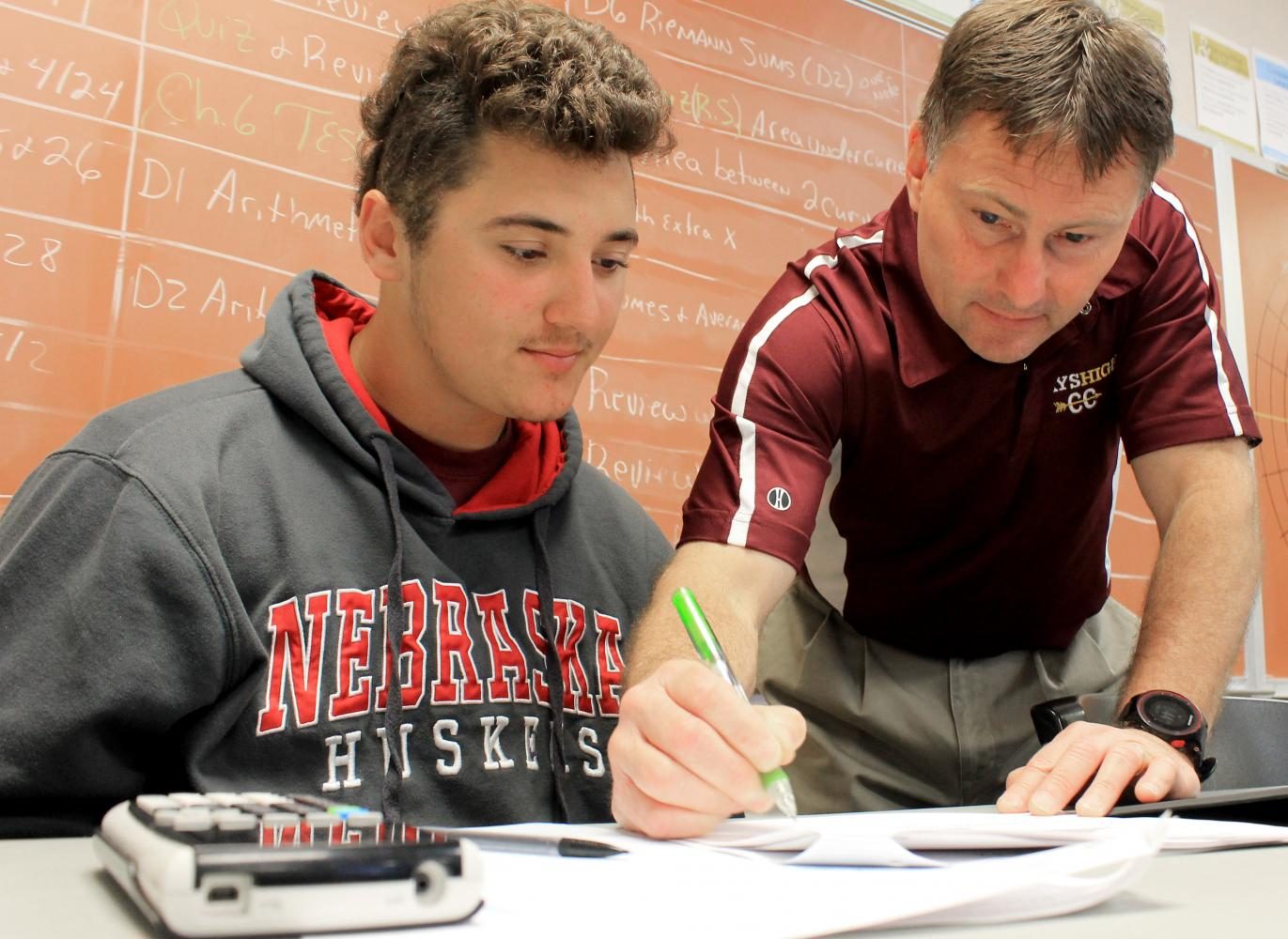 Before Calculus Methods, instructor Jerold Harris spends some extra time tutoring senior Tyrone Wynn on April 24. “The best part of my job is the moment when students finally understand a concept they have been struggling with,” Harris said. “I feel like I am actually making a difference and that is why I continue to do this.”