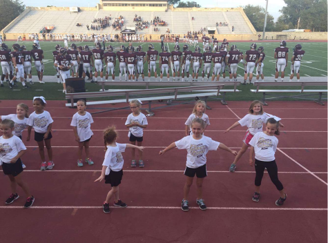 Kids cheering during first quarter of the football game. 