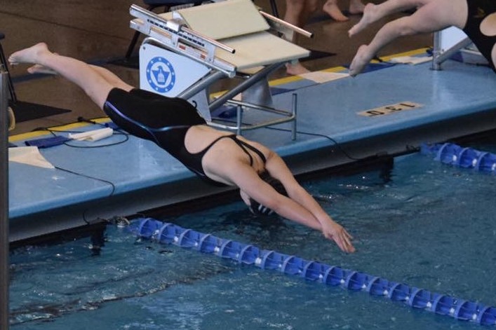 Sophomore+Megan+Flavin+dives+into+the+water+for+her+500+freestyle+at+State.+This+was+Flavins+first+year+at+State.