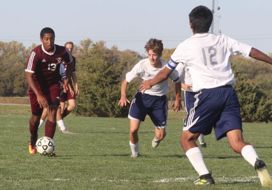 Junior Trey McCrae dribbles at the TMP defense in a recent cross town rivalry match up, where the Indians won 7-2.
