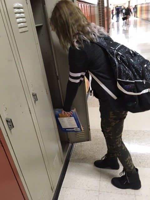 Junior+Katie+Vaughn+puts+her+textbook+in+her+locker.