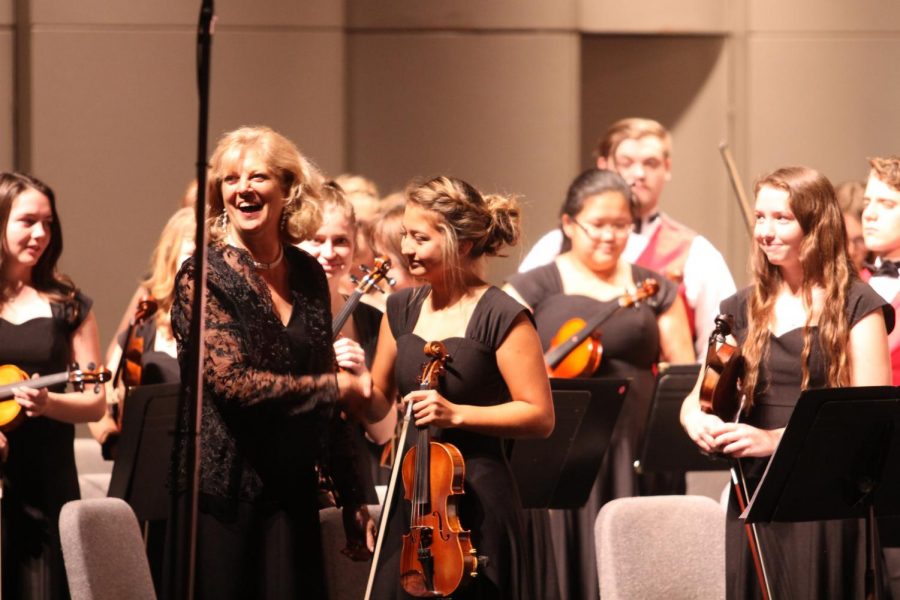 Senior Trinity Callis, seen shaking hands with instructor Joan Crull, has made it into KMEA District Orchestra all four years of her high school career.