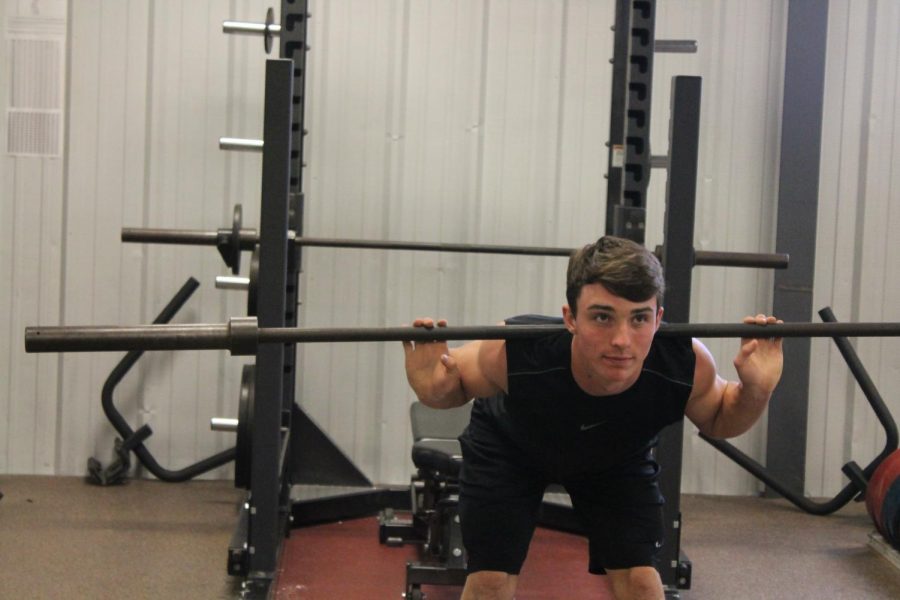 Garret Rymer lifts in weightlifting class.