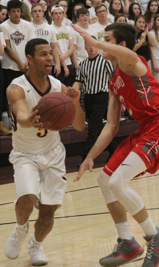 Senior Ethan Nunnery looks past Great Bend defender for a pass to the paint.