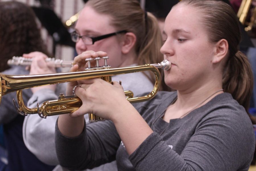 Sophomore Chloe
Fitzhugh plays her trumpet during a break in the Basketball game. 
