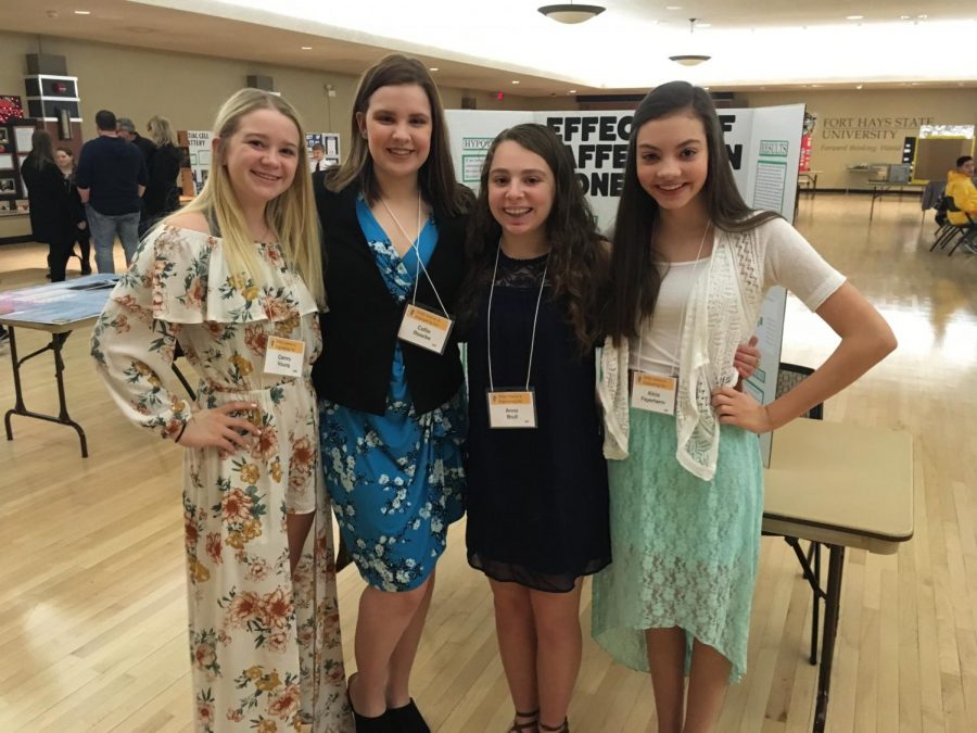 Freshmen Camry Young, Callie Raacke, Anna Brull, and Alicia Feyerherm pose for a picture before the science fair. Freshmen Audrey Rymer and Emily Kreutzer also competed.