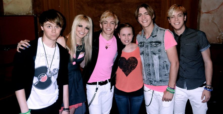 Junior Zoe C. Martin poses with the members of R5 at a concert. Martin attended the R5 concert when she was 11 years old.