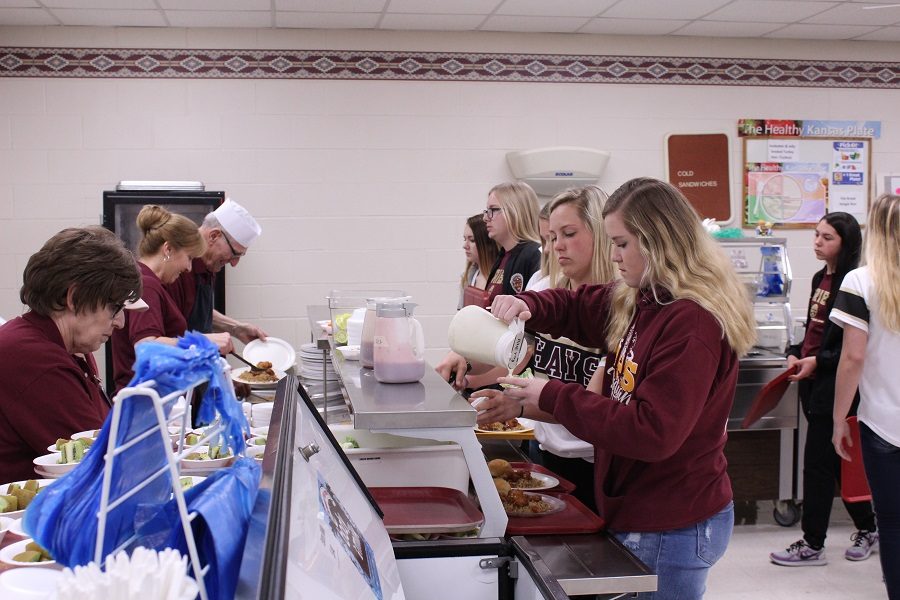 Students make selections on their way through the lunch line. With potential new rule enforcement, all students will be allowed only 20 minutes for lunch.