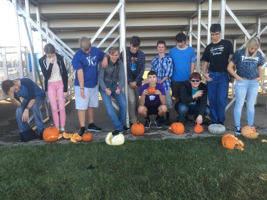 Physics students pose with their pumpkins after testing their acceleration due to gravity. 