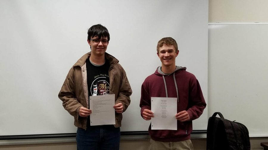 Freshman Andrew Duke and sophomore Levi Hickert stand with their winning poems. 