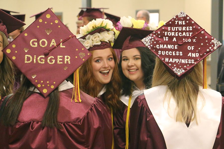 Graduated seniors Hannah Donaldson and Abby Balman wear their decorated caps for graduation. 