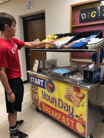 Senior Peyton Thorrel grabs breakfast from the Grab-and-Go Breakfast Cart before school. The cart runs 7:25 to 7:51 every morning.