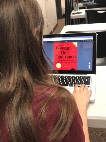 Sophomore Alicia Feyerherm looks at a Scholar's Bowl practice book. This is Feyerherm's second year participating in Scholar's Bowl.