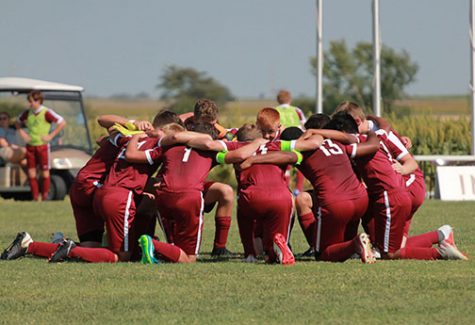 Th boys soccer team praying before their game against Wichita Classical that resulted in a 4-2 win for the Indians.