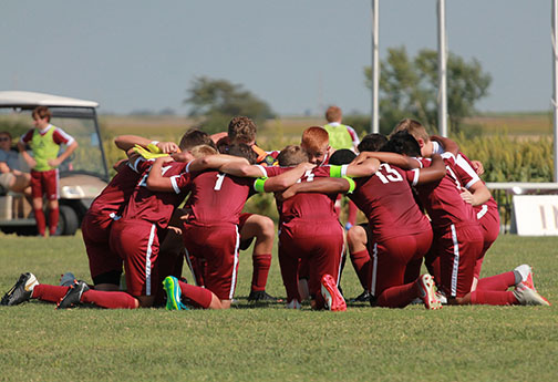 Th boys soccer team praying before their game against Wichita Classical that resulted in a 4-2 win for the Indians.