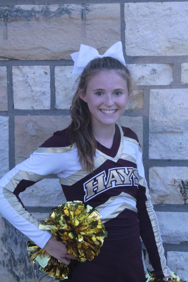Freshman Landri Dotts poses for her cheer picture at Maroon and Gold. Dotts is involved in both cheer and cross country.