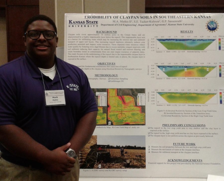 Mathis poses with his poster about Erodibility of claypan soils in Southeastern Kansas at the 2017 Governors Water Conference. 