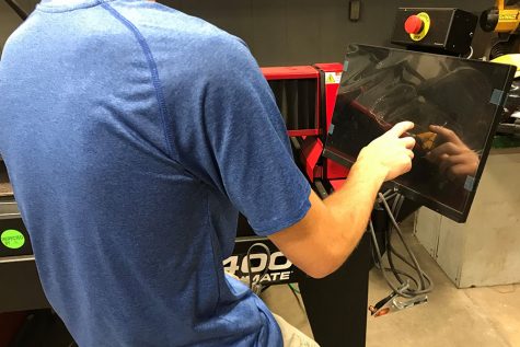 Junior Marshall Meier prepares to use the new plasma cutter in the welding room.