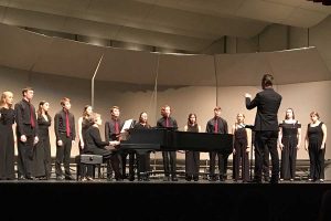 Vocal director Alex Underwood conducting Chamber Singers during the Fall Concert