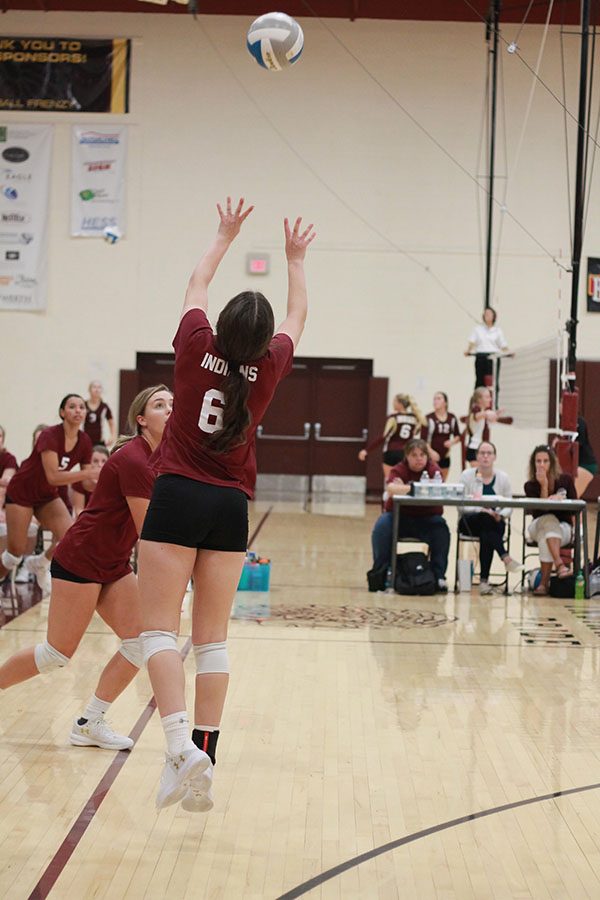 Senior Hannah McGuire setting up a hitter at the recent home game where the team went 2-1. 