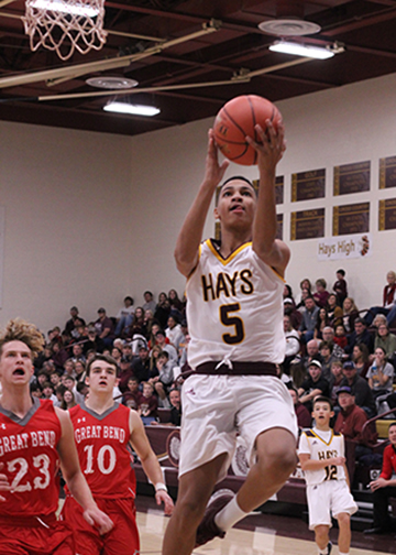 Sophomore T.J. Nunnery drives to the basket after beating two Great Bend Panther defenders.