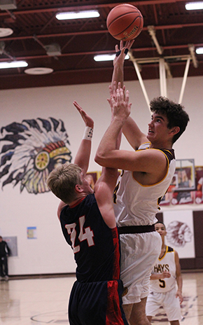 Sophomore Trey Adams pulls up for a hook shot over a Manhattan defender . Indiana fell to Manhattan 56-78. 