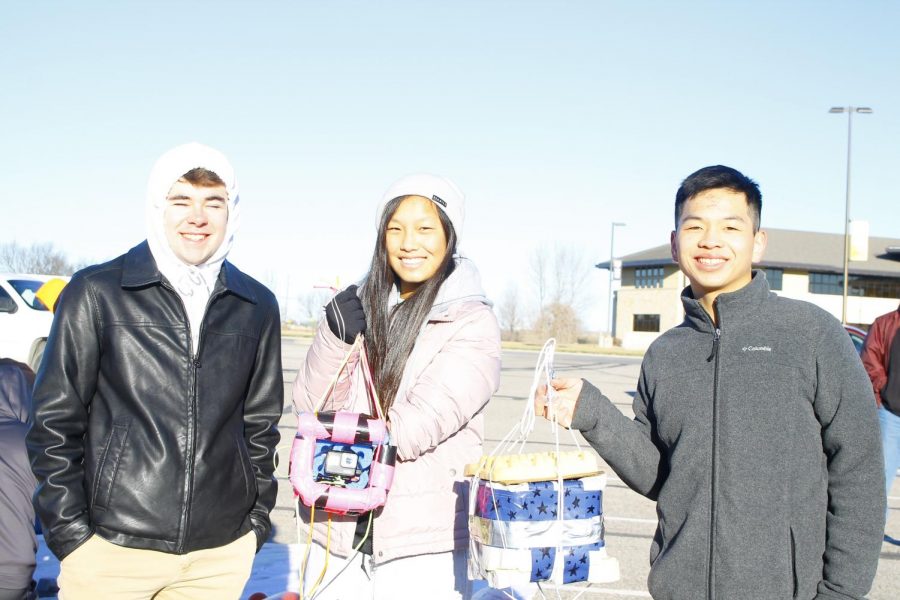 Seniors Cameron Karlin, Cori Isbell and Joey Wei pose with their packages. 