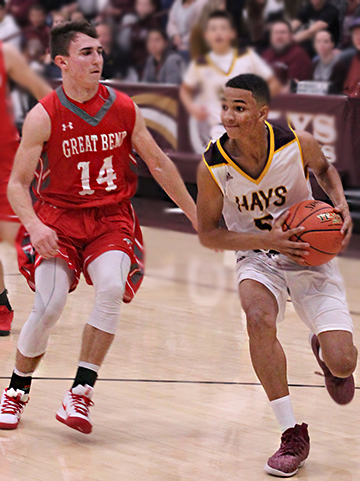 Sophomore TJ Nunnery drives to the basket after beating two Great Bend defenders on a fast break in Hays City Shootout.