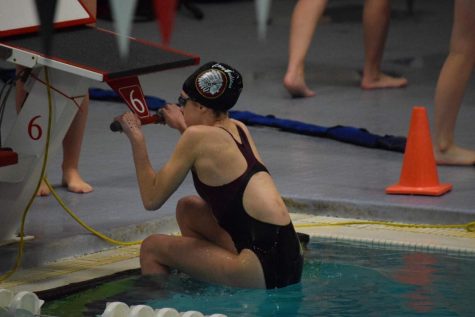 Sophomore Kaitlyn Christen prepares for her 100 yard backstroke. She placed 7th with a time of 1:32.09.