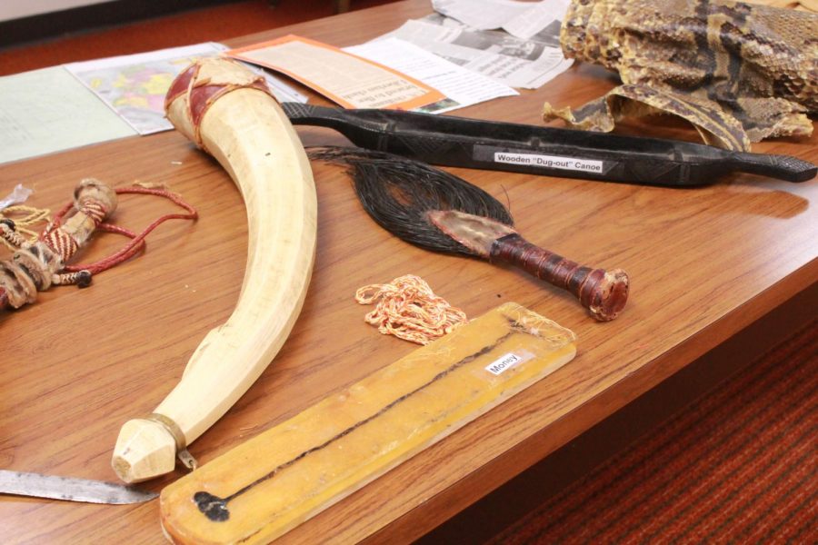 Folkerts had laid out the artifacts across a couple tables in the library for students to look at and ask questions about. Some of these included horns, replicas of boats and money. 