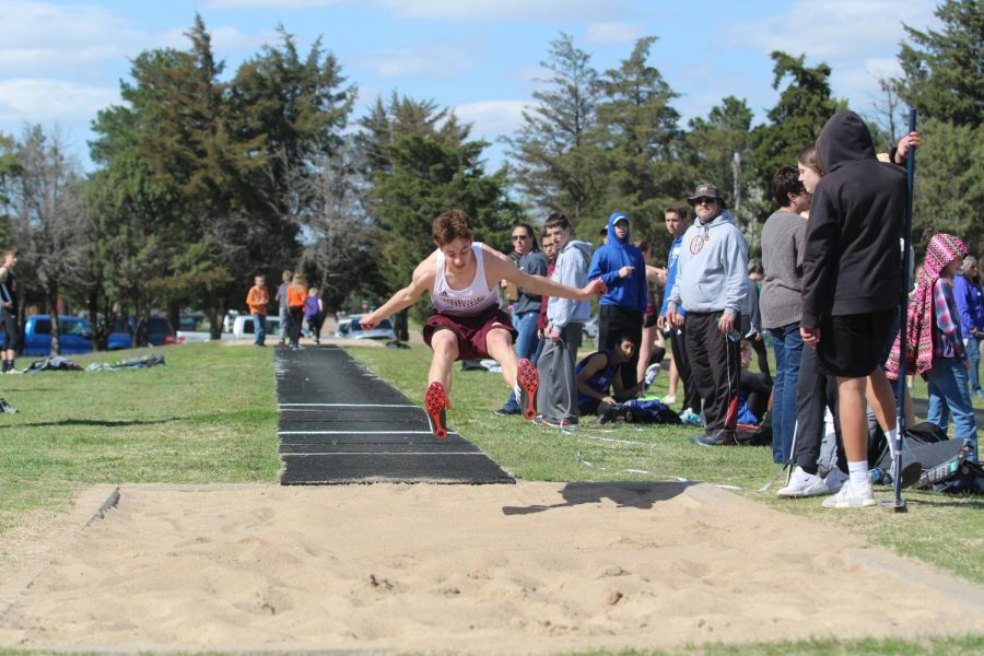Sophomore Kyler Beckman jumps at a previous track meet in Larned. Both track teams competed at the McPherson Varsity Invitational on April 25.