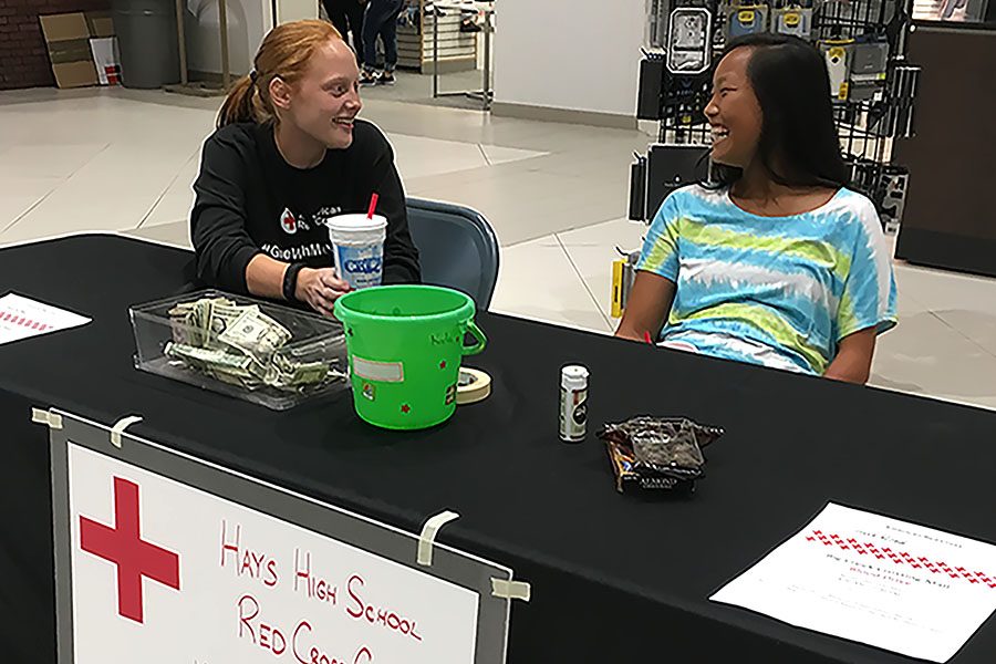 Red Cross Club members Lynsie Hansen and Cori Isbell collect donations at the mall. Cori Isbell was the Red Cross Club 