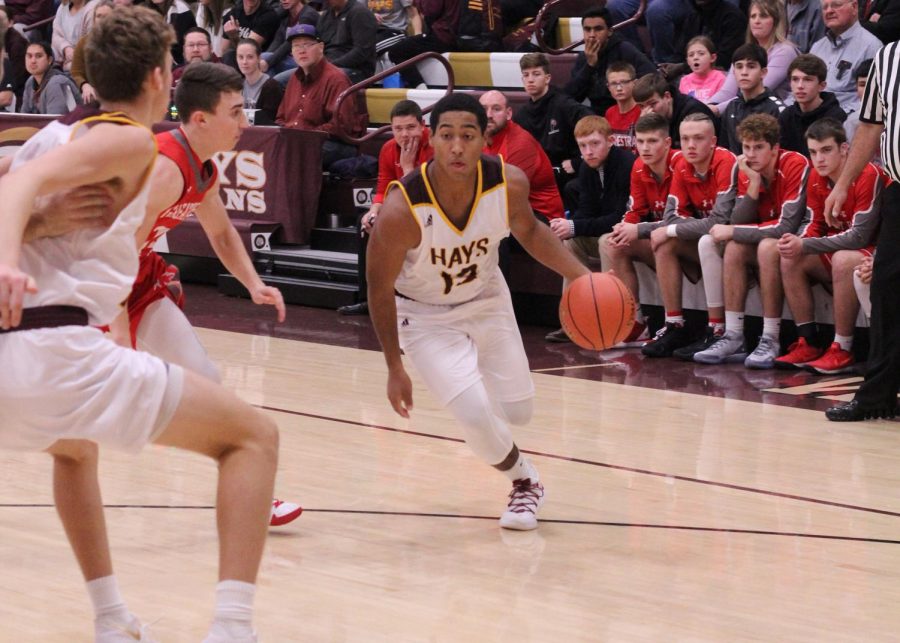 Tradgon McCrae a 2019 graduate dribbles the ball down the court during a basketball game at home last year. 