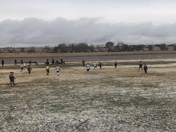 The Boys soccer team plays Ark City at home on Oct. 28. The weather was not very pleasant for a soccer match, with snow falling through the duration of the match. 