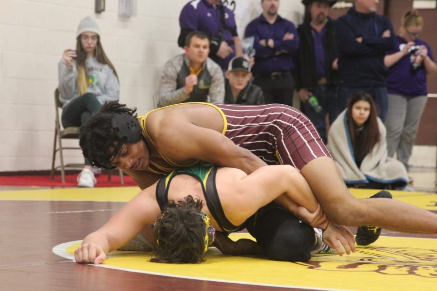 Senior DaVontai Robinson pins his opponent during his first match on Saturday.