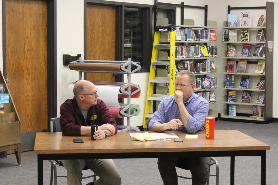 Administors Lance Krannawitter and Martin Straub think about an answer for the Kansas City Chiefs Trivia in the Library. Straub and Krannawitter ended the trivia in first place.