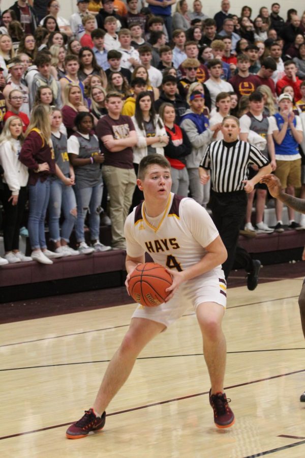 Sophomore Carson Kieffer looks for one his teammates to pass to during the home game on Feb. 21. 